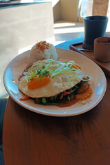 Sautéed rice with spices and egg on a white plate