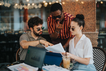 Business partners discussing over a new business project, planning, and analyzing statistics while strategizing in a modern coffee shop.