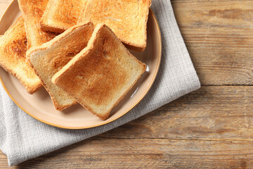 Delicious toasts on wooden table, top view