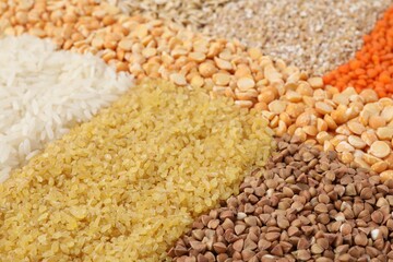 Different types of cereals and lentils as background, closeup