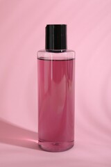 One shampoo in bottle on pink background