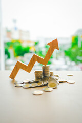 Up Arrow symbol with coins stack. Concepts of the banking system, rising interest rates, inflation,...