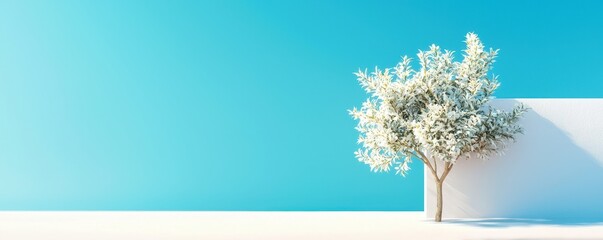 A minimalist scene featuring a white tree against a vibrant blue background, perfect for themes of tranquility and nature.
