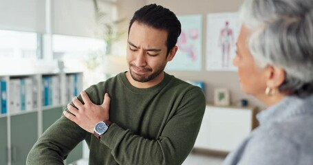 Physiotherapist, talking and man with shoulder pain, injury and chiropractor for body recovery or help. Consulting, muscle tension or client explaining in physiotherapy for rehabilitation service