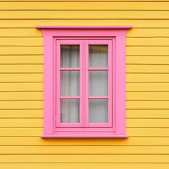 Front view of a pink window on a yellow wooden house wall.
