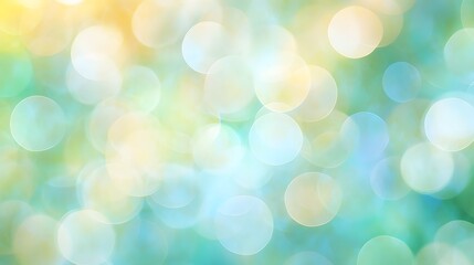 Obraz premium A soft, dreamy bokeh background with overlapping circles in pastel shades of blue, green, and yellow. The abstract light effect creates a soothing and airy atmosphere, perfect for serene designs.