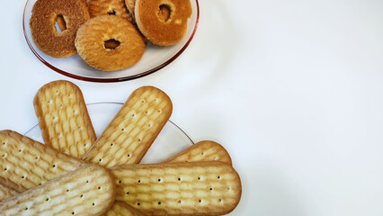 Plates with crispy biscuits on the white background with copy space.
