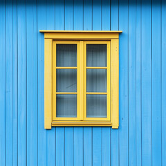 Obraz premium Front view of a yellow window on a blue wooden house wall.