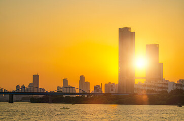 Sunsets behind the skyscrapers of yeouido and bridges across the Han River in Downtown Seoul, South...
