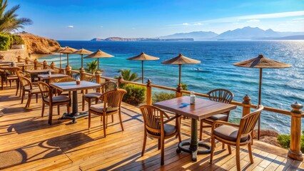 Obraz premium Relaxing cafe with outdoor seating overlooking the Red Sea coastline in Sharm El Sheikh, Egypt, cafe
