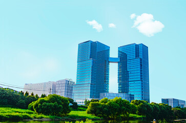 Sustainable glass office building with trees for reducing carbon dioxide. Eco-friendly building in modern city.