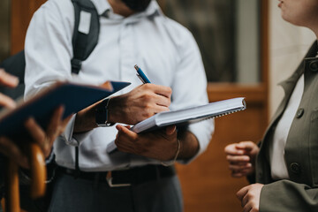 Fototapeta premium Young business people brainstorming project ideas, discussing strategy and market trends in an outdoor meeting in urban city downtown.