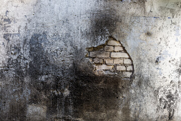 Burned Dirty Brick Wall With Crumbling Stucco Texture Background