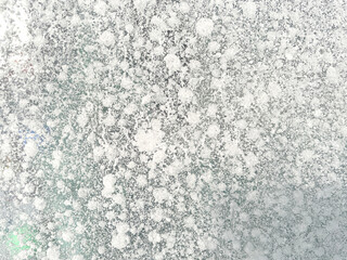 Ice texture background close up. Textured cold frosty surface of ice block with frozen air bubbles.
