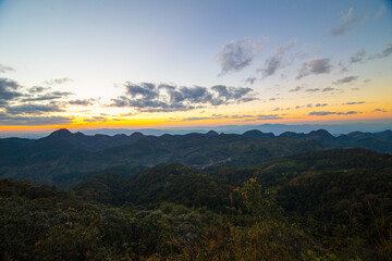 Colorful sky sunset on peak of mountain tropical forest