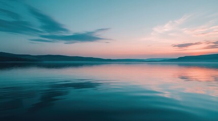 Obraz premium A serene lake at sunset, reflecting soft colors and tranquil waters.