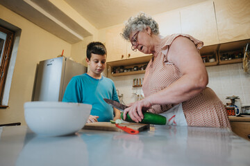 An elderly woman and her grandson preparing food in a home kitchen. The scene captures family bonding, learning, and the joy of cooking together.