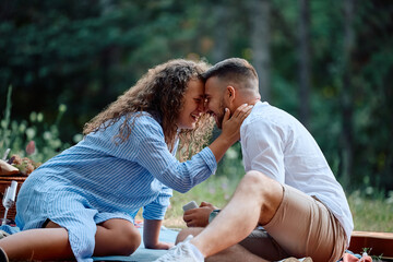 Affectionate couple enjoying in their love while getting engaged in nature.