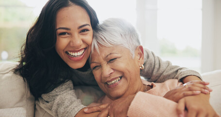 Hug, portrait and smile of old woman with daughter on sofa in living room of home for bonding or...