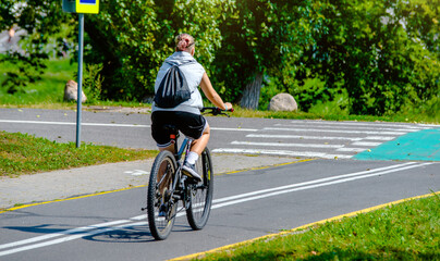 Cyclist ride on the bike path in the city Park
