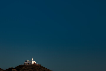 Obraz premium Mexican church on hilltop clear sky background