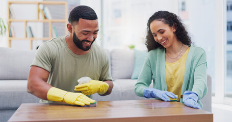 Couple, spray and cleaning for table in home with smile with sponge, shine and polish in living room. Man, woman and happy for teamwork, bonding and gloves with hygiene, bacteria and wood in house