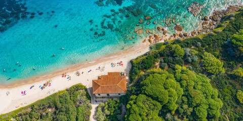 Fototapeta premium Mediterranean beach seen from above on a sunny summer day. Turquoise sea, fine white sand and green pine forest. People relax under colorful umbrellas.
