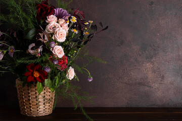 Autumn composition made of beautiful flowers on dark backdrop. Floristic decoration. Natural floral background