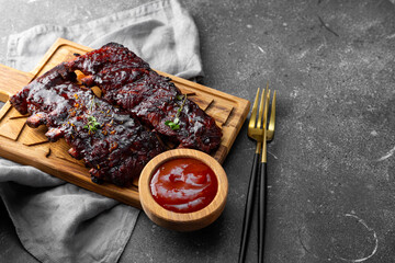 Roasted Pork Ribs in BBQ Sauce on the grey background