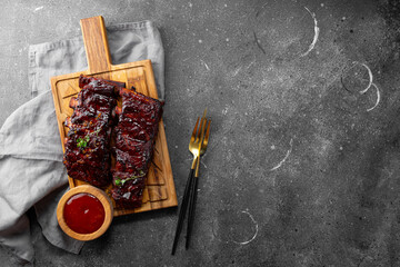 Roasted Pork Ribs in BBQ Sauce on the grey background top view copy space for text