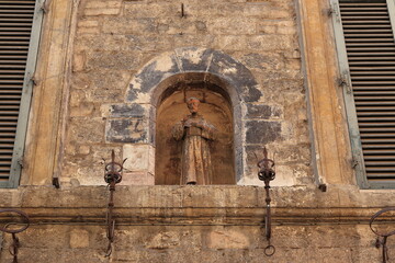 Assisi Building Facade Detail with Statue of Saint Francis in Umbria, Italy