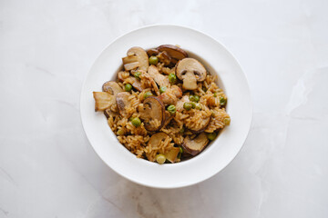 Overhead view of a plate with rice with pork and mushrooms