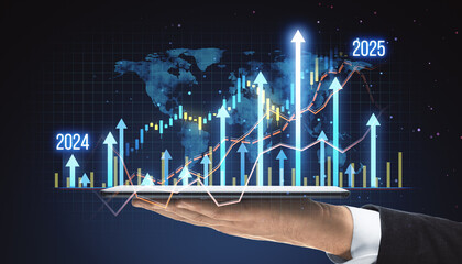 Businessman holding a tablet with digital financial graphs, showing upward trends for 2024 and 2025.