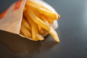 Golden French Fries in Paper Bag