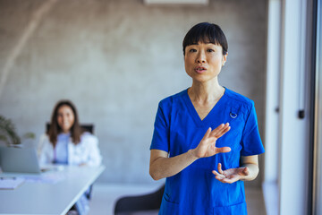 Confident Medical Professional in Blue Uniform Giving Presentation