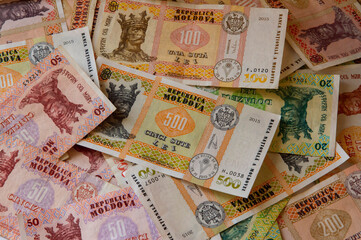 close-up: Moldovan leu banknotes of 10 lei 20 lei 50 lei 100 lei 200 lei 500 lei lying randomly on a table