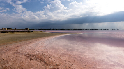 Clouds and rain over the Midi salt marshes, dead seaweed, France