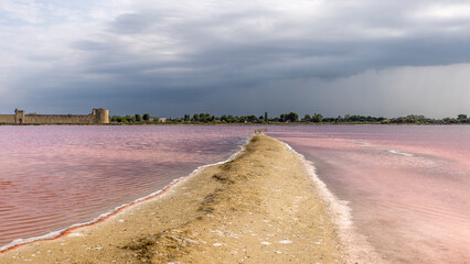 Clouds and rain over the Midi salt marshes, dead seaweed, France
