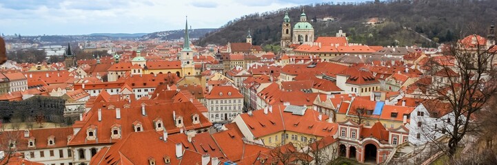 Obraz premium Aerial view of Prague's historic red-roof buildings, perfect for travel blogs promoting European culture and architecture tourism