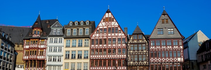Traditional half-timbered houses against a clear blue sky in Frankfurt, Germany, capturing historic European architecture, ideal for travel concepts