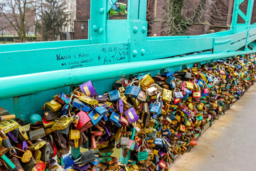 Colorful love locks attached to a bridge in Wrocaw, symbolizing eternal love and romantic...