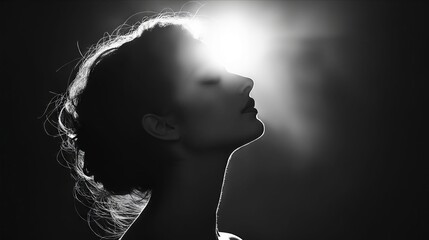 A black and white photo of a woman with her eyes closed