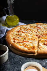flatlay pizza with sweet and sour sauce, smoked chicken and pickled onions, fresh pizza on a wooden board, tomato sauce, olive oil and soy sauce, lunch, pizzeria