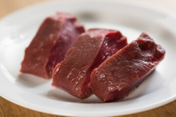raw filet mignon steaks on white plate