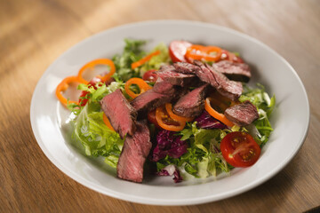 salad with sliced filet mignon steak