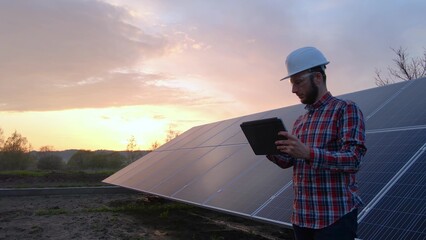 Technical engineer analysing solar farm solar panels data, digital future