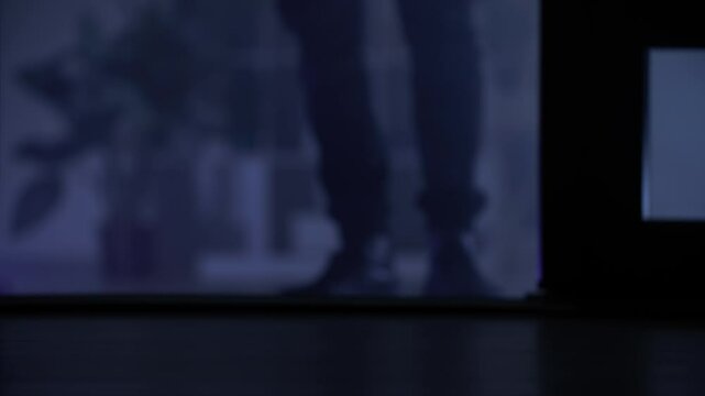 trespassing, male person opens door and enters premises at night, close-up of legs