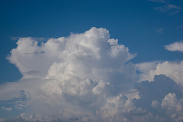  Beautiful white anime-looking clouds over a blue sky for the background.