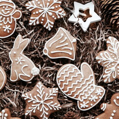 New Year's background with gingerbread. Christmas cookies and a garland on a craft background. Flat lay. Top View