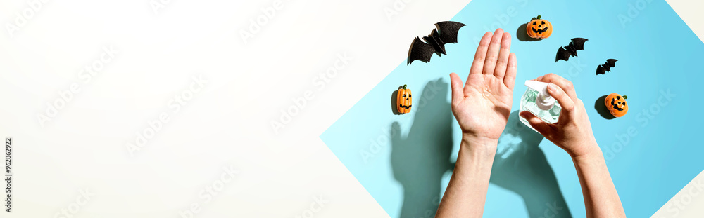 Wall mural Applying sanitizer gel with Halloween theme - healthcare and hygiene concept